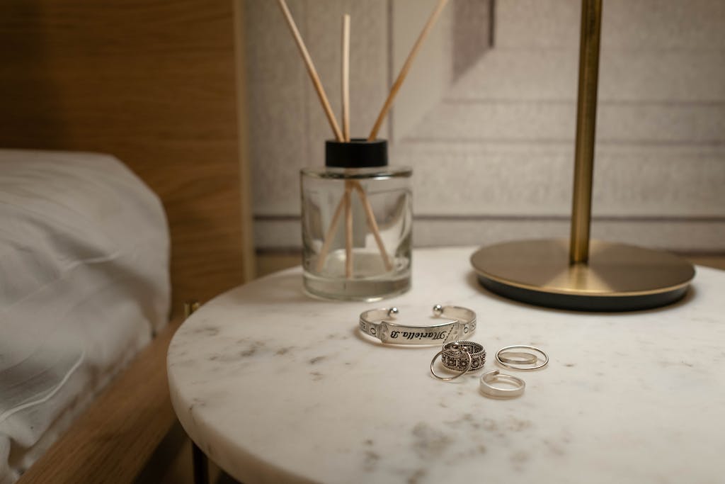 Photo of Rings and a Bracelet on a Bedside Table